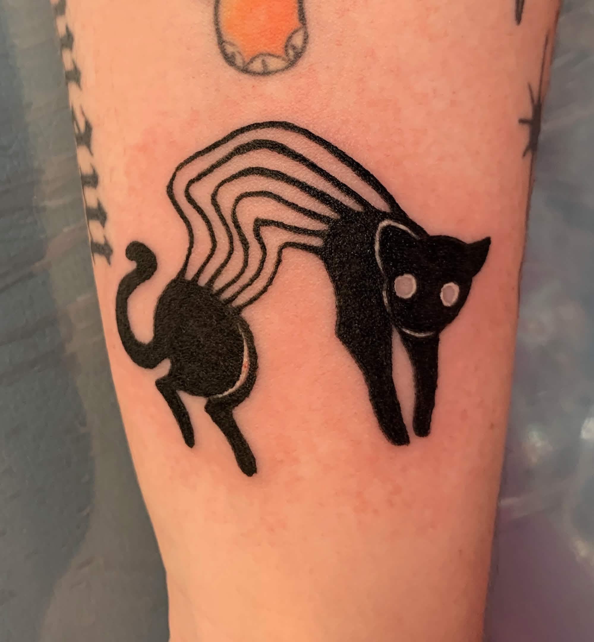 tattoo of a stretched out black cat